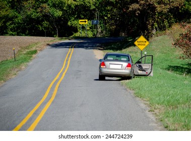 An Abandoned Car On The Side Of The Road With A Door Open. Quick Exit Or Foul Play?