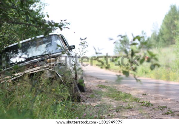 abandoned car on the side of\
the road