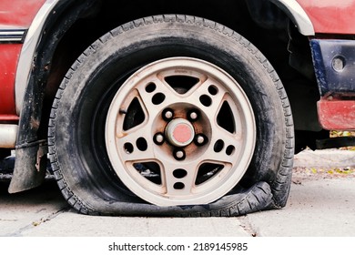 Abandoned Car On The Street. Flat Tire And Tire Burst