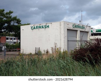 Abandoned car wash with white walls that looks abandoned.