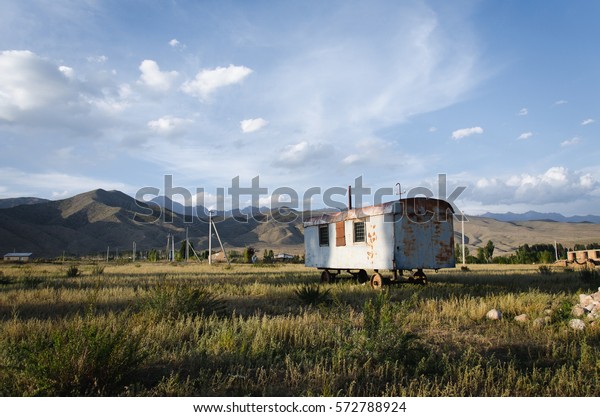 Abandoned caravan staying in Kyrgyz mountains,\
sunny weather