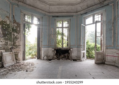Abandoned castle, room with fireplace and large broken windows - Shutterstock ID 1955243299