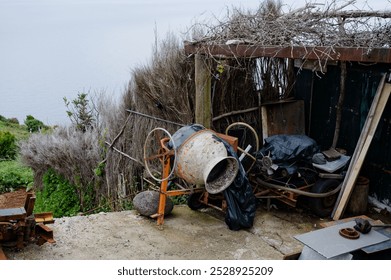 Abandoned cement mixer by madeira’s coastline, a relic of past construction efforts. - Powered by Shutterstock