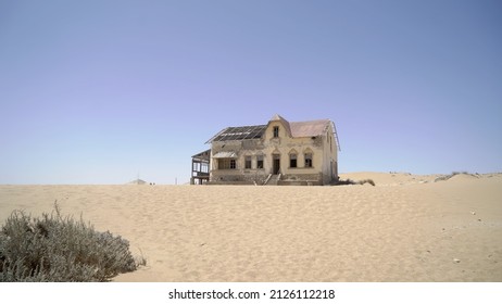 Abandoned city of Kolmanskop in Namibia. Ancient city covered with sand in the desert of Africa. Diamond mine. Ghost town. Old ruin in dunes outdoors.