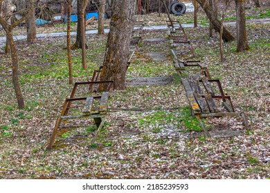 Abandoned city park with broken benches . Forsaken town park - Shutterstock ID 2185239593