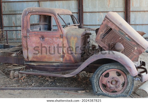 Abandoned\
Classic Pick Up Truck Rusting in a Barn with Flat Tires Model T,\
Ford, on a Condemned Ranch in\
California