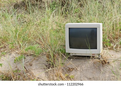 Abandoned computer screen on beach