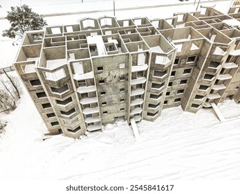 An abandoned concrete structure lays bare under snow, showcasing winter's harshness in the city. - Powered by Shutterstock