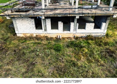 Abandoned construction site reinforced concrete monolithic house  Abandoned building materials  Stop financing construction  Shooting from drone