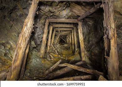 Abandoned copper ore mine underground tunnel with collapsed wooden timbering - Shutterstock ID 1699759951