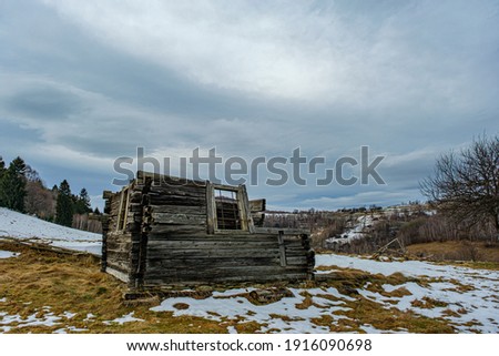 abandoned cottage on the hills in winter