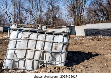 Abandoned Damaged Bulk Plastic Tote At An Industrial Construction Site