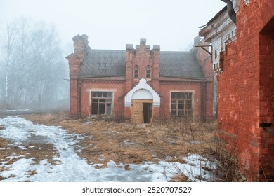 Abandoned Decaying brick building in a foggy rural landscape with broken windows - Powered by Shutterstock