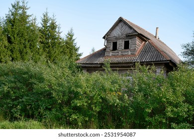 Abandoned dilapidated wooden village house by the forest in the Yaroslavl region in Russia - Powered by Shutterstock