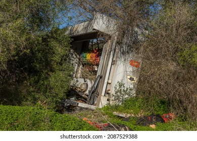 Abandoned and disused industrial car wash machine in a Mediterranean forest on a sunny day. Image of incivism throwing waste in nature