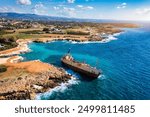 Abandoned Edro III Shipwreck at seashore of Peyia, near Paphos, Cyprus. Historic Edro III Shipwreck site on the shore of the water in Cyprus. Aerial view of Shipwreck EDRO III, Pegeia, Paphos.