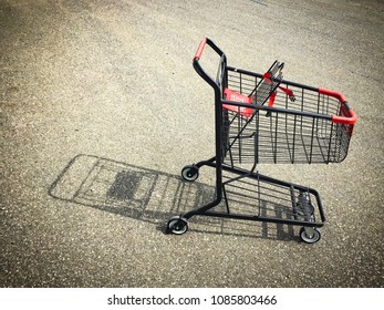 Abandoned Empty Shopping Cart In Parking Lot