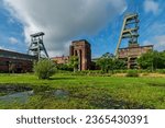  The abandoned Ewald colliery in Herten in Germany in front of a muddy meadow                              