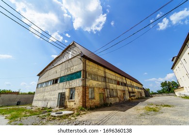 Abandoned factory house. Old industrial building outdoor view on sunny summer day.