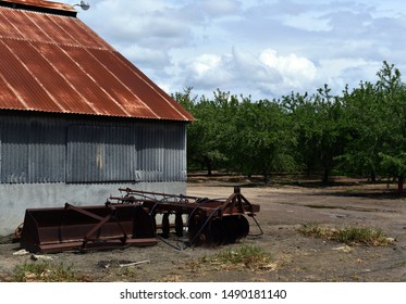 Abandoned Farm Building With Red Metal Siding