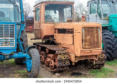 Abandoned Farm Equipment. Old Tractors Are Rusty And Broken.