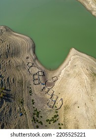 Abandoned Fish Farm On Dried Soil On Lake Bed Due To Global Warming And Drought