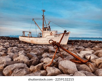 An abandoned fishing boat anchored off the coast of Iceland  - Shutterstock ID 2259132215