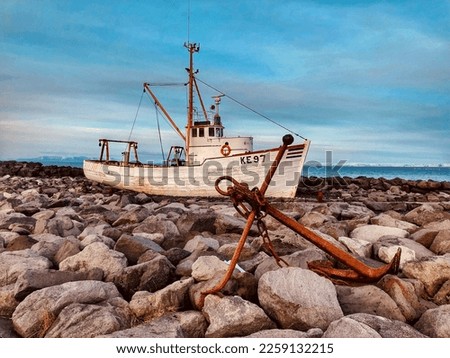 An abandoned fishing boat anchored off the coast of Iceland 