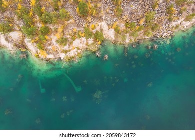 abandoned or flooded pit mining. Quarry panoramic view. Environmental problems in flooded quarry, aerial view of industrial quarry with flooded equipments, abandoned and flooded quarry