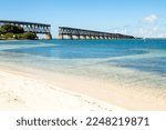 Abandoned Florida Overseas railway bridge over blue ocean water of Gulf of Mexico, Calusa beach in Florida Keys, Bahia Honda State Park,