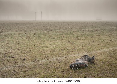 Abandoned football (soccer) boots left by side of pitch on a foggy morning - Powered by Shutterstock