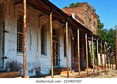 An Abandoned Group Of Buildings Including An Old Bank, Line The Main Street Of The Small, Rural Texas Town Of Neches