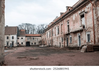 Abandoned Historical Courtyard with Weathered Architecture and Overgrown Surroundings. - Powered by Shutterstock