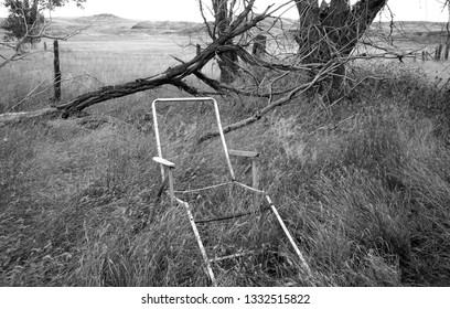 An Abandoned Home With A Broken Vintage Lawn Chair In Black And White