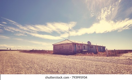 Abandoned House By A Gravel Road, Color Toned Picture, Patagonia.