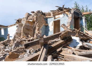 An abandoned house collapses. The house is destroyed. Cracks in wall of house. Destruction of old houses, earthquakes, economic crisis, abandoned houses. Broken unfit house