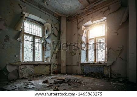 Abandoned house interior, dirty room, rotten peeled walls.
