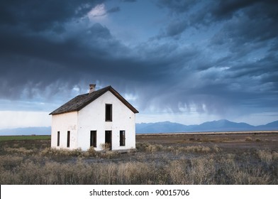 An Abandoned House Is Overcome By A Dark And Eerie Sky