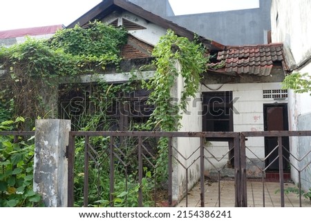 Abandoned house overgrown with vines, Location in Kranggan Cibubur Indonesia