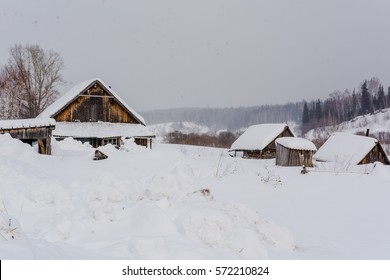 The Abandoned House In Russia Under Snow. Siberia, The Thrown House A Roof In Snow.