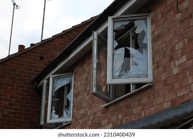 Abandoned house with two open smashed windows UK - Shutterstock ID 2310400439