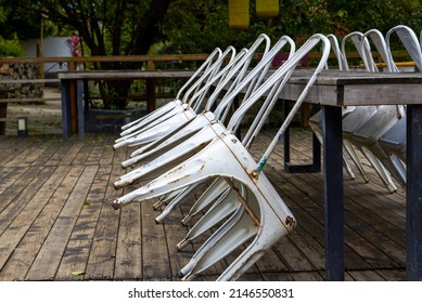 Abandoned Long Conference Table And Stools Outdoors