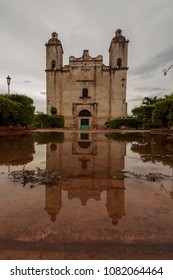 Abandoned Mexican church on a rainy afternoon. The storm is now over and water puddles give the town sqare a magic touch