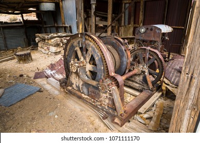 Abandoned Mine Hoist House And Machinery Room With Old Mining Equipment.