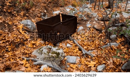 An abandoned mine's minecart in Arizona's Madera Canyon, in the Santa Rita Mountains, in fall leaves and trees, near Sahuarita, Green Valley, Tucson, and Tubac, in winter of 2023. 