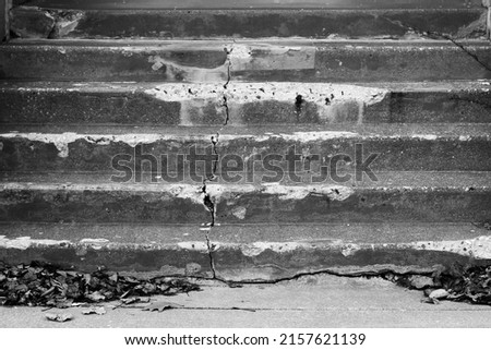 Abandoned neglected old concrete stairs
in black and white.