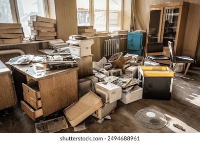 Abandoned office room with different old broken equipment and garbage