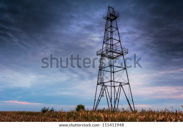 Abandoned oil rig, dramatic clouds and evening sky