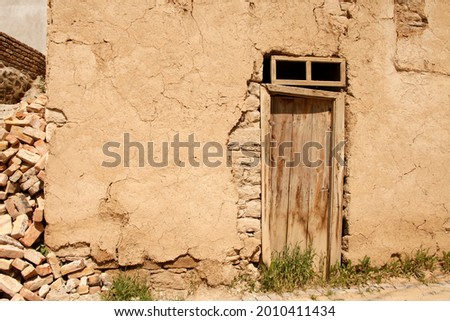 abandoned old adobe house and wooden door