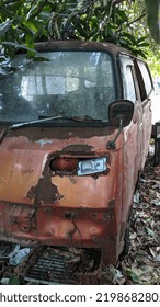 Abandoned Old Car Wreck Under A Lush Tree